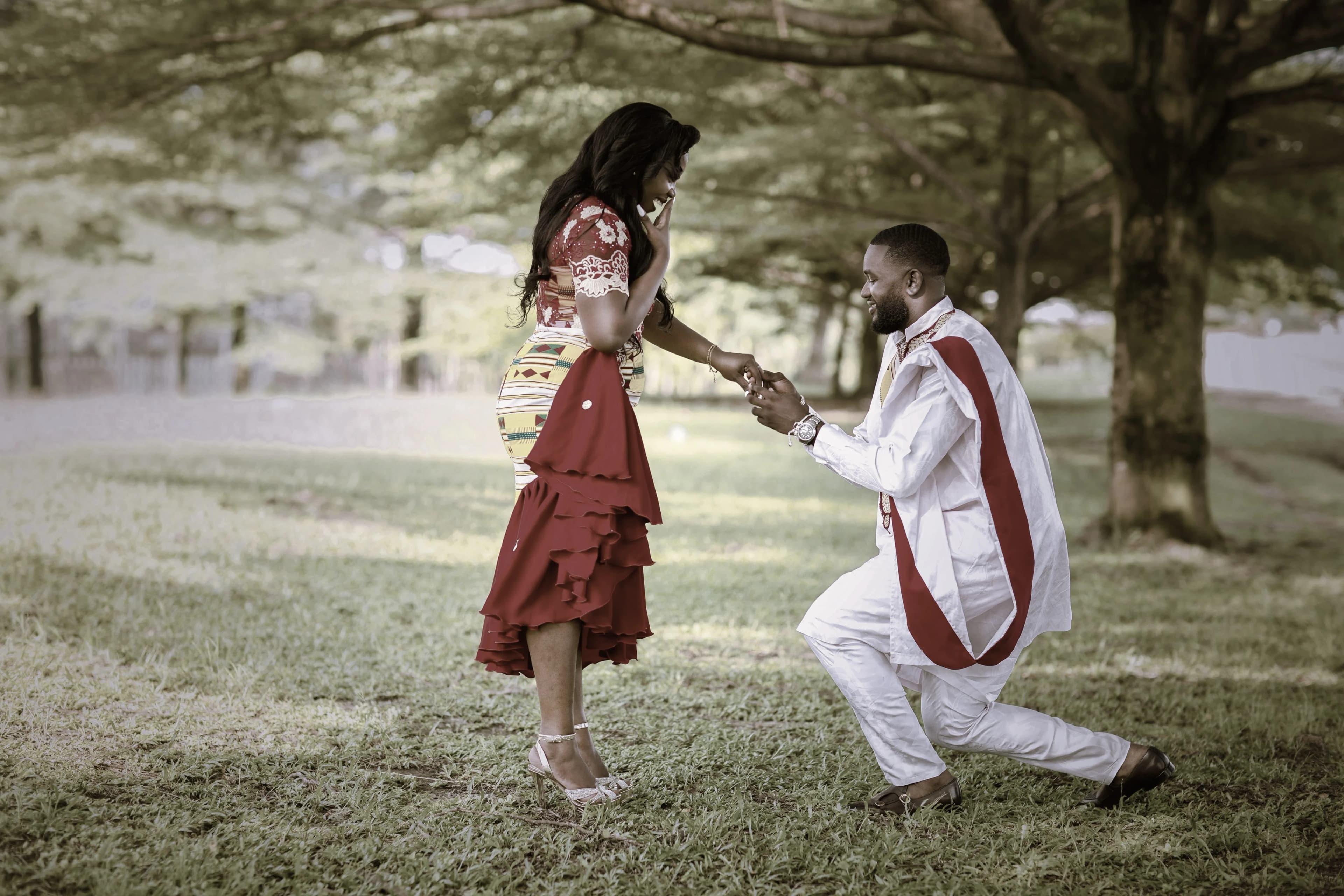 A man proposing to his partner in a park