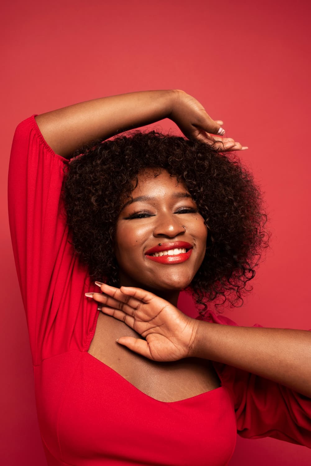 A smiling woman dressed in red
